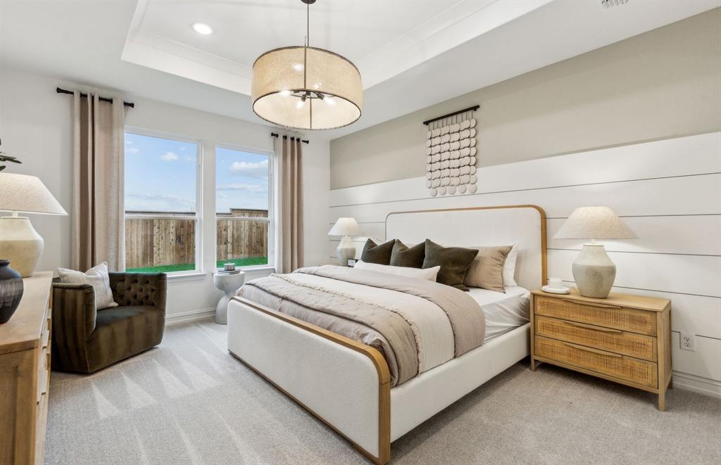 1600 Tyler Drive Anna, TX 75409 - Photo 9 of 14 a spacious bedroom with a bed a chandelier and a large window