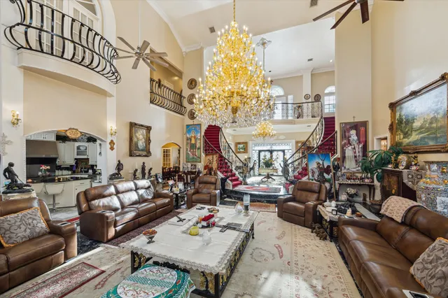 a living room with patio furniture and a chandelier