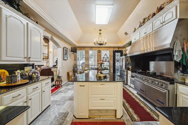 a kitchen with stainless steel appliances a stove a sink and a refrigerator