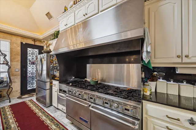 a kitchen with stainless steel appliances granite countertop a stove and a microwave