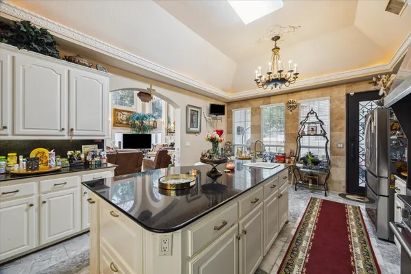 a kitchen with sink cabinets and living room