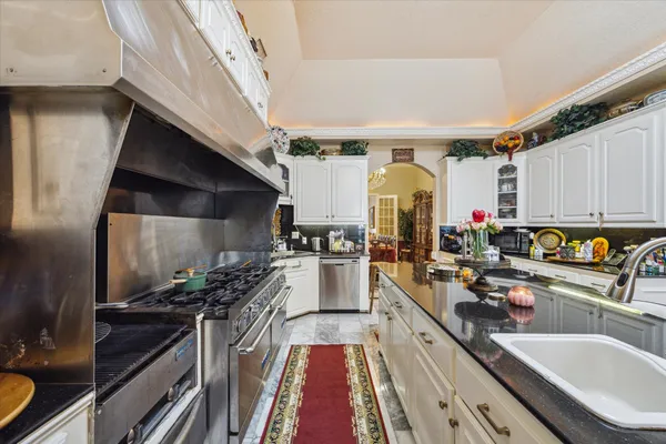 a kitchen with lots of counter top space and stainless steel appliances