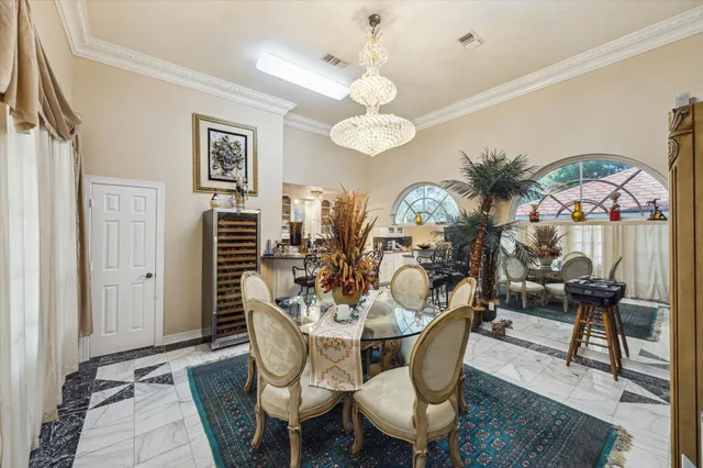 a view of a dining room with furniture and chandelier