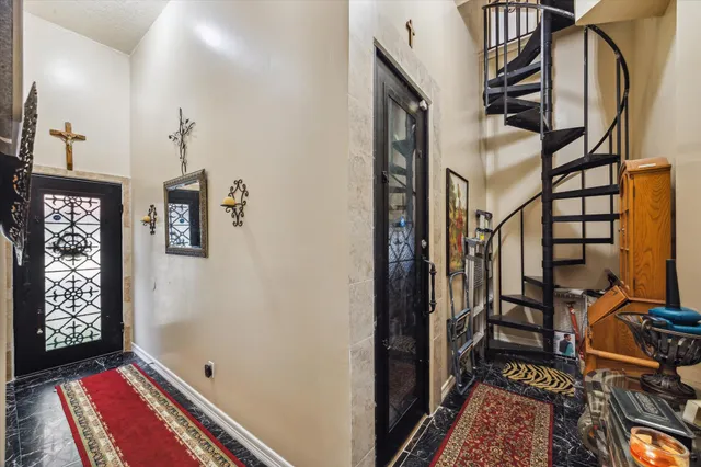 a view of an entryway with bench and door