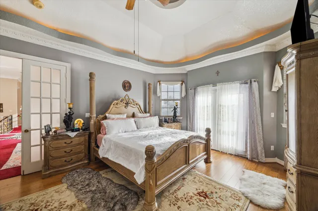 a bedroom with a large bed and a chandelier