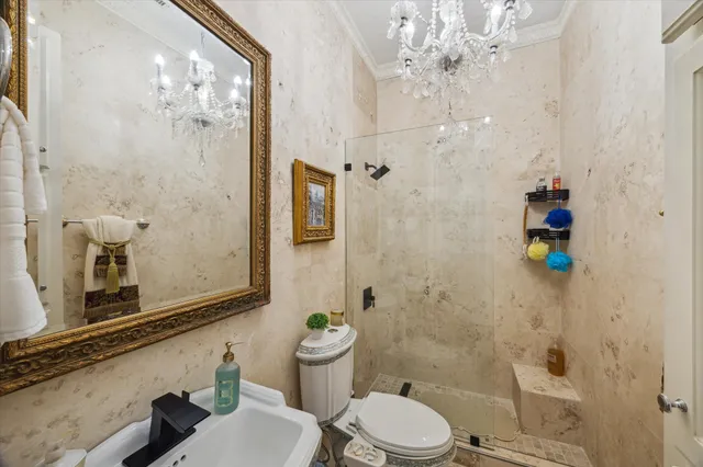 a bathroom with a granite countertop shower a toilet and a sink