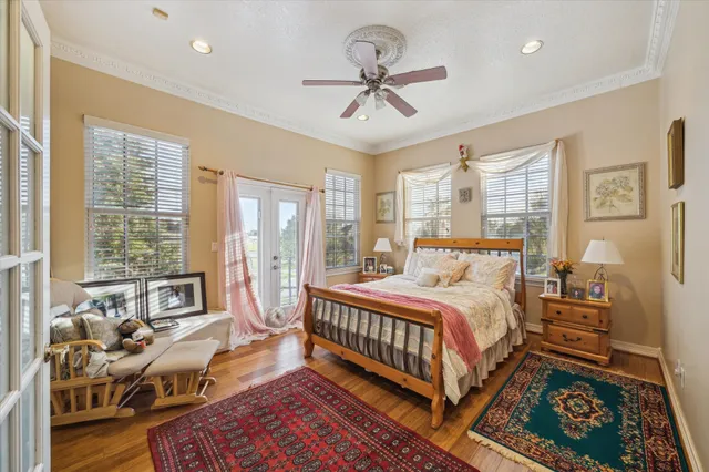 a bedroom with a bed and wooden floor
