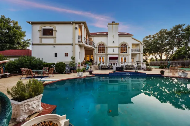 a aerial view of a house with swimming pool garden and patio
