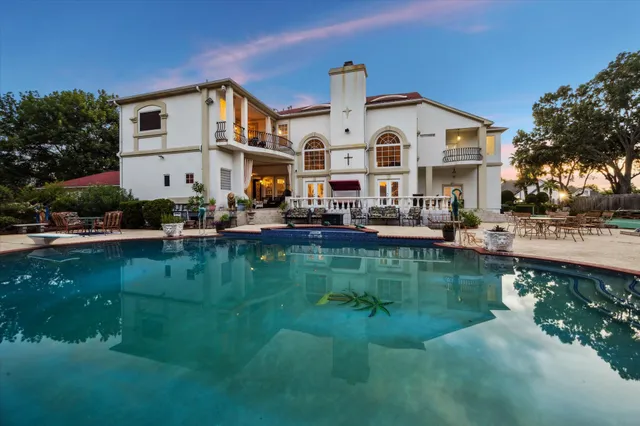 a front view of a house with garden and lake view