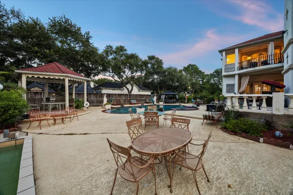 a view of a house with backyard sitting area and garden