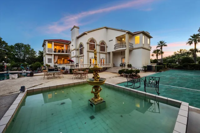 a swimming pool with outdoor seating and yard