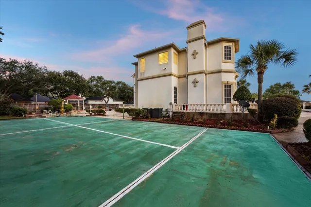 a view of a big house with a big yard and potted plants