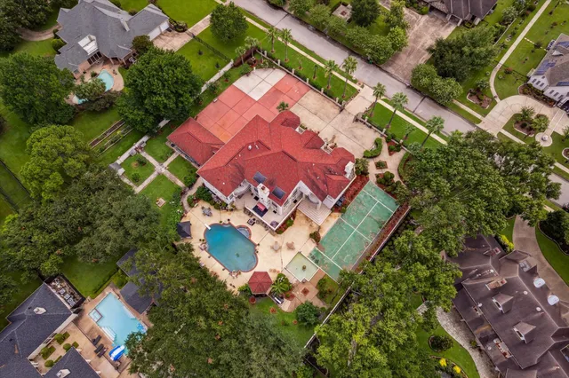 an aerial view of a house with a yard