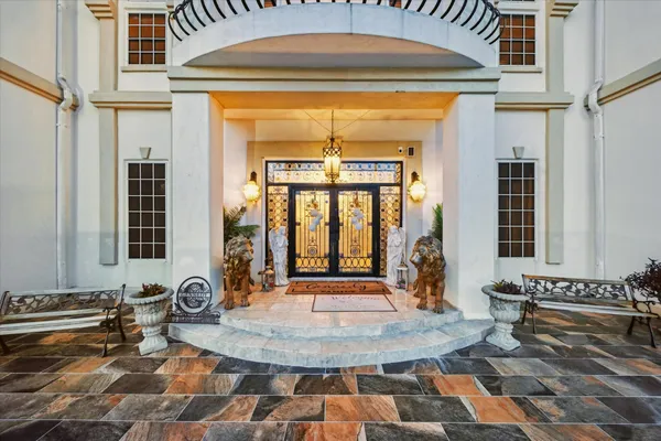 a view of a hall with a dining table and chairs