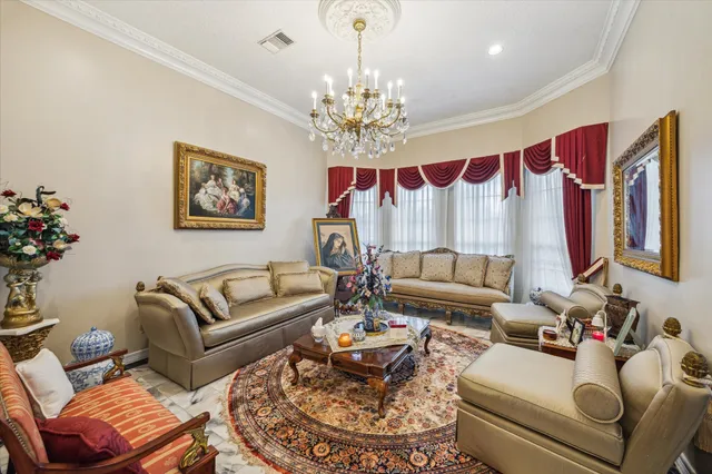 a living room with furniture a chandelier and a fireplace