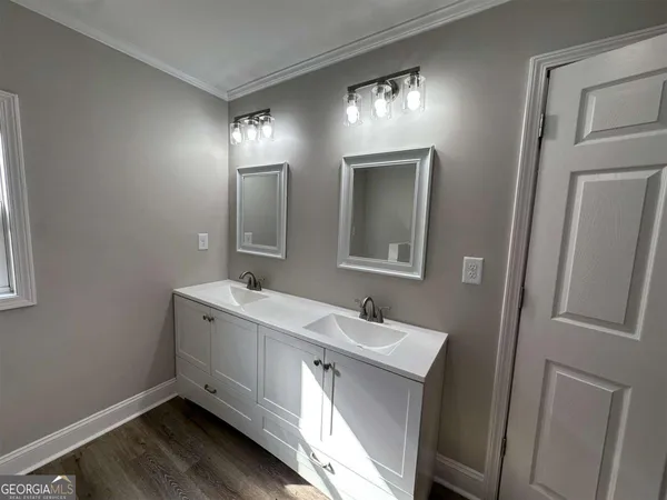 a bathroom with a double vanity sink and mirror