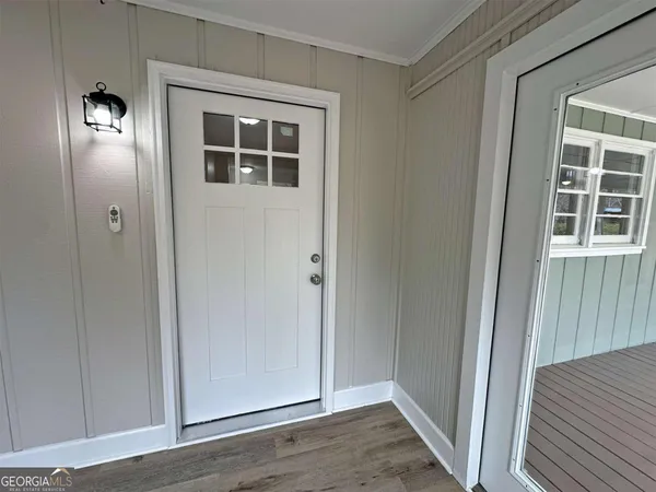 wooden floor in an empty room with a door