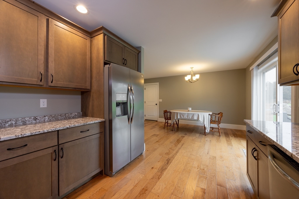 194 A Narrows Road Westminster, MA 01473 - Photo 11 of 31 a kitchen with stainless steel appliances granite countertop a refrigerator a stove and a wooden floors