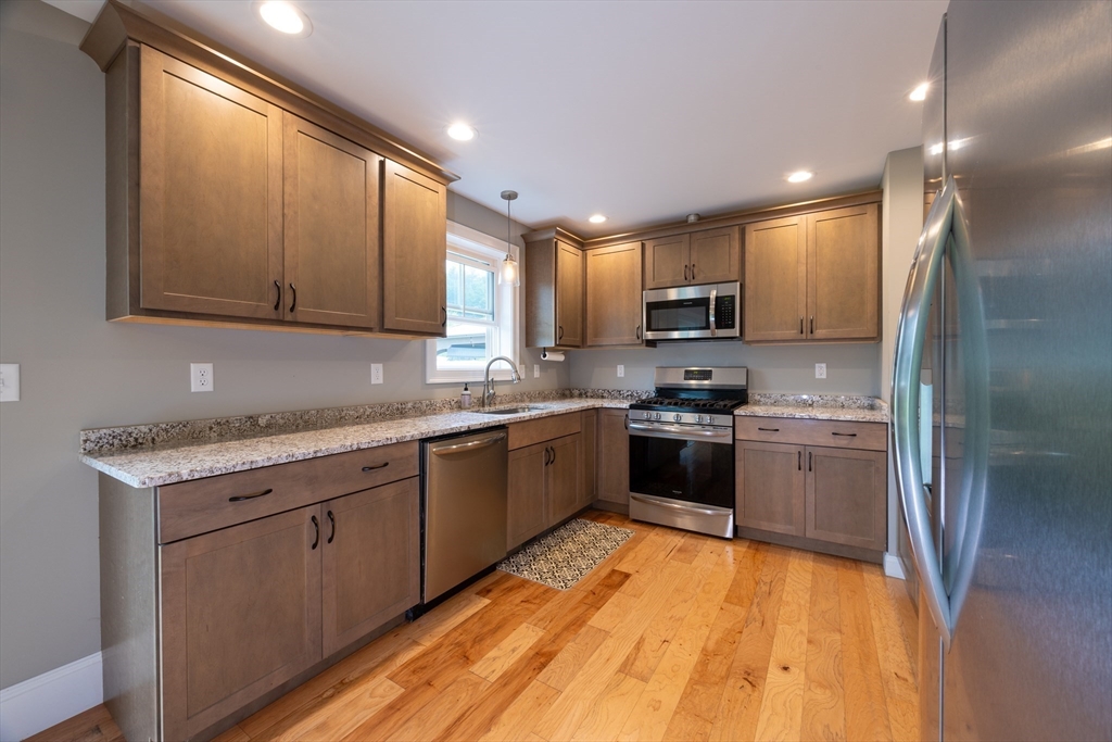 194 A Narrows Road Westminster, MA 01473 - Photo 12 of 31 a kitchen with stainless steel appliances granite countertop a stove top oven a sink and dishwasher a refrigerator with wooden floor