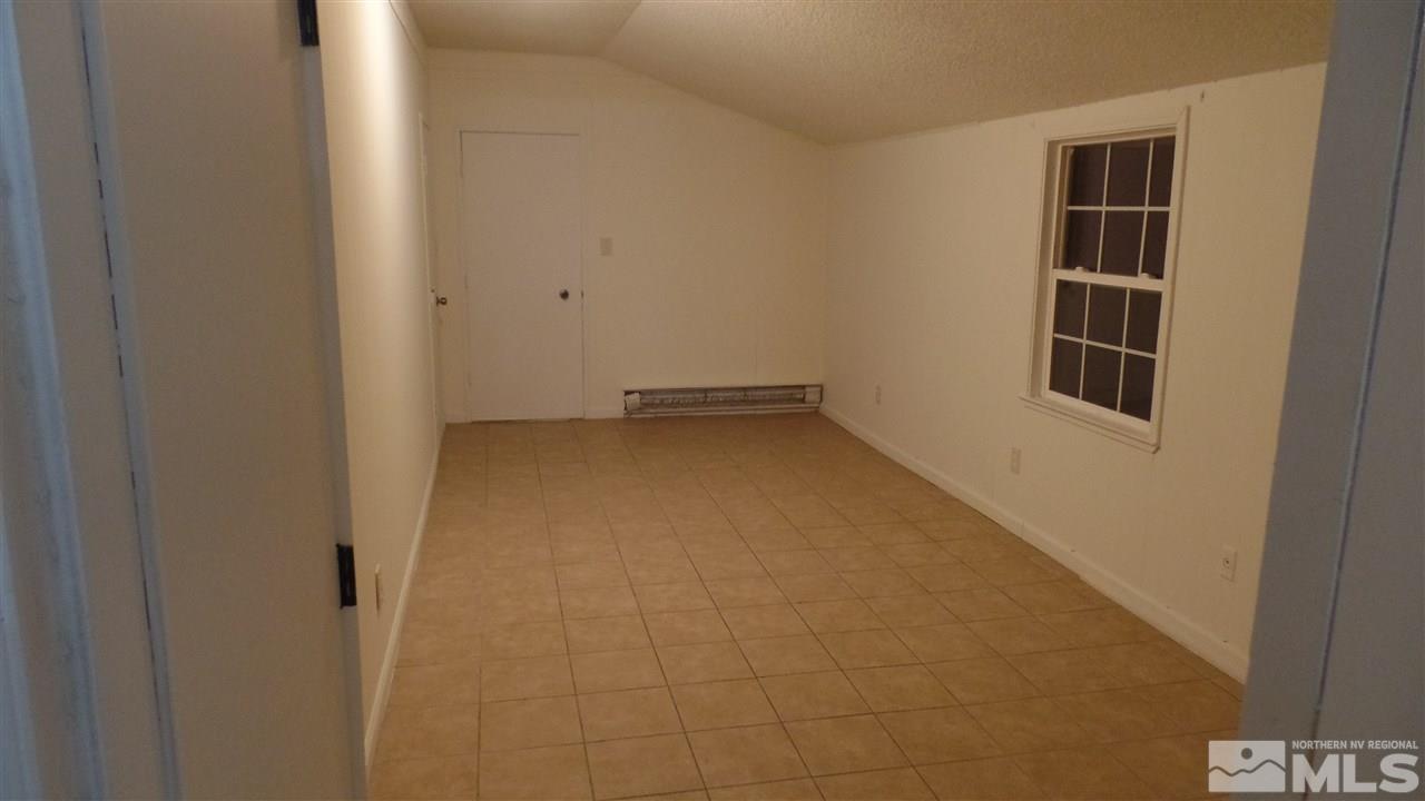 8900 Turbine Way Reno, NV 89506 - Photo 12 of 19 a view of an empty room with wooden floor and cabinets