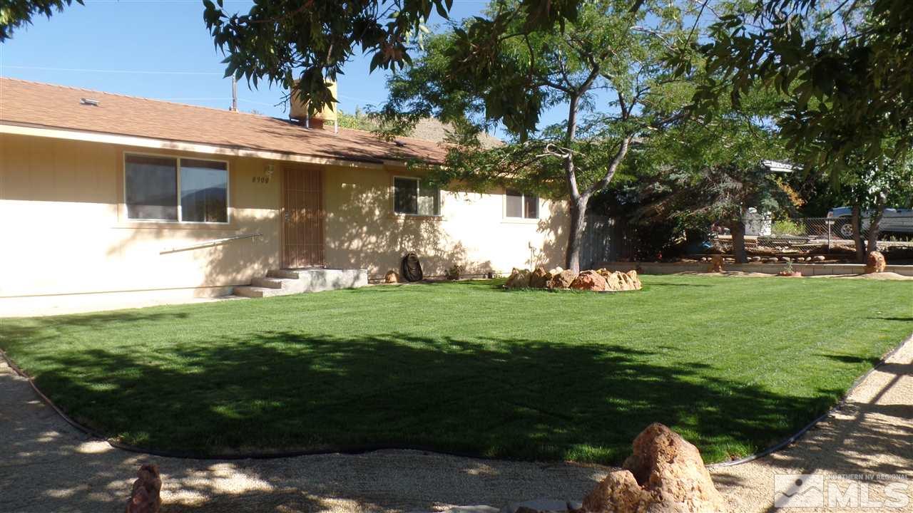 8900 Turbine Way Reno, NV 89506 - Photo 4 of 19 a view of a white house with a big yard and potted plants