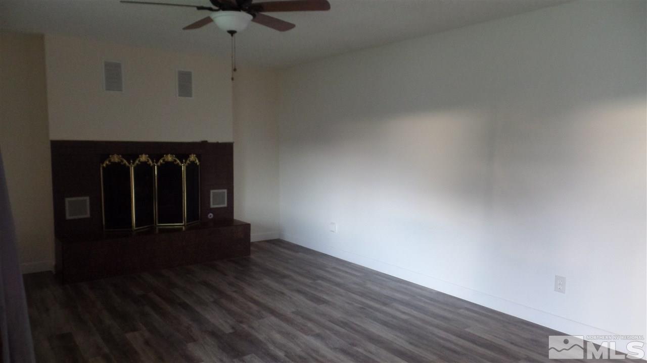 8900 Turbine Way Reno, NV 89506 - Photo 9 of 19 a view of a hallway with wooden floor and a cabinet