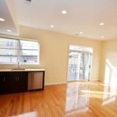 a large kitchen with stainless steel appliances granite countertop a sink and cabinets with wooden floor