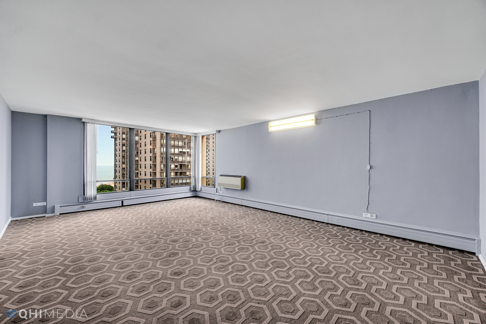 5740 North Sheridan Road, Unit 12C Chicago, IL 60660 - Photo 2 of 19 a view of an empty room with a window