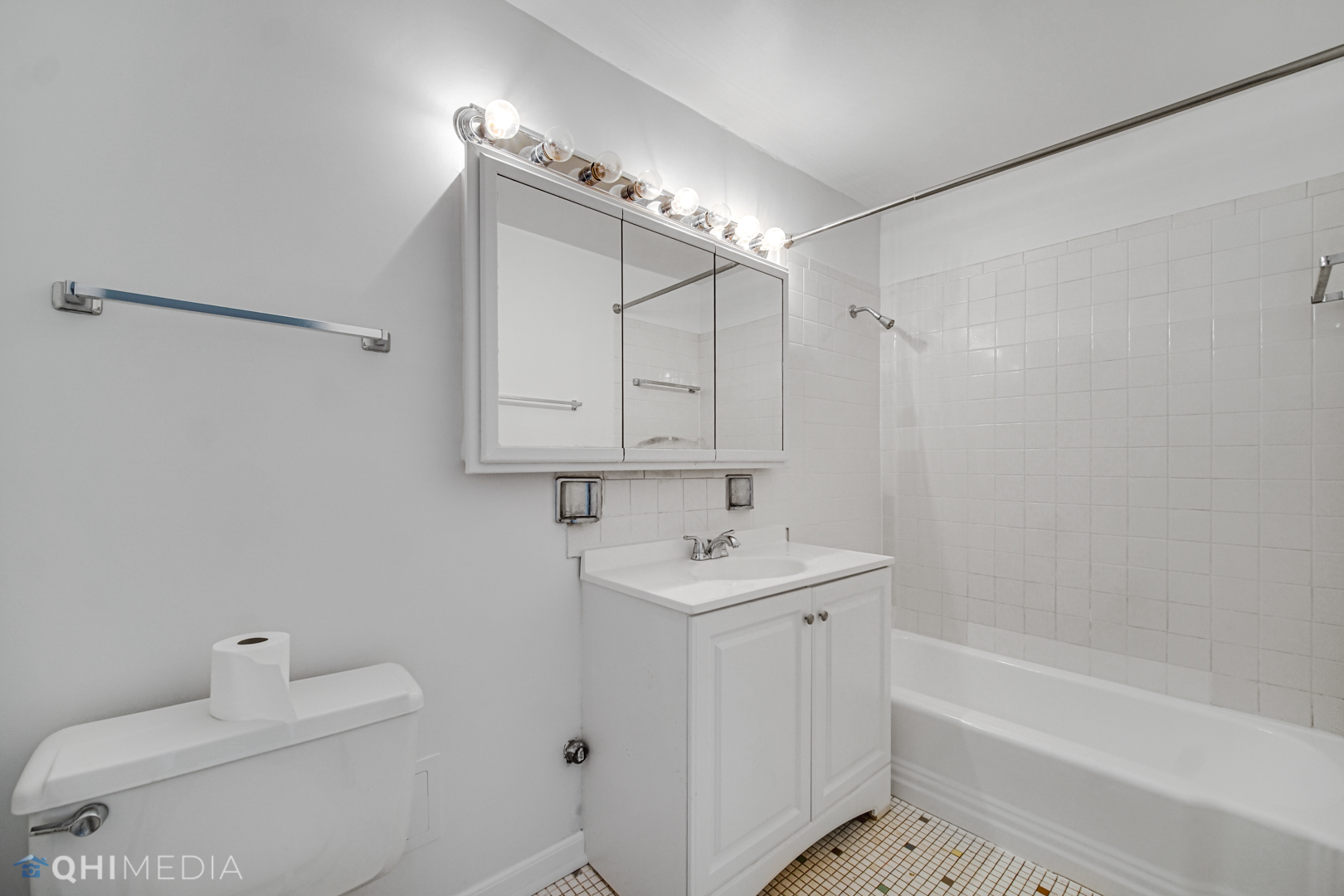 5740 North Sheridan Road, Unit 12C Chicago, IL 60660 - Photo 12 of 19 a bathroom with a sink a toilet and shower