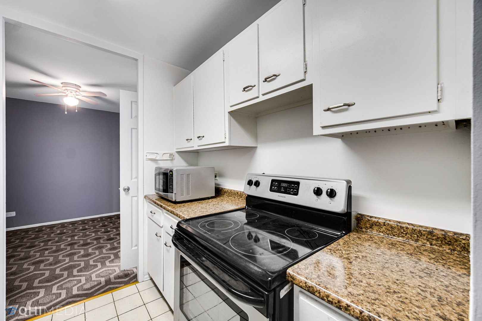 5740 North Sheridan Road, Unit 12C Chicago, IL 60660 - Photo 13 of 19 a kitchen with granite countertop a stove and a sink