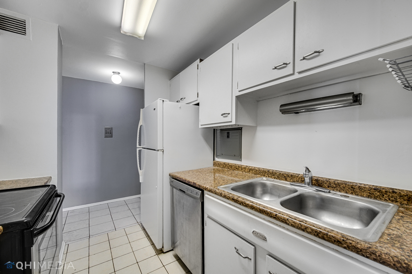 5740 North Sheridan Road, Unit 12C Chicago, IL 60660 - Photo 16 of 19 a kitchen with a refrigerator and a sink