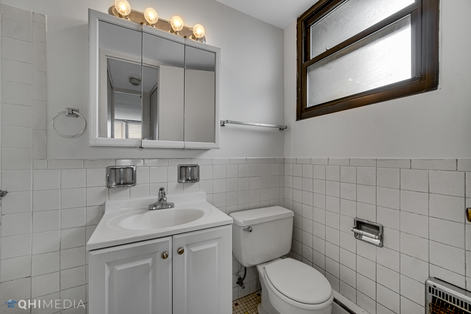 5740 North Sheridan Road, Unit 12C Chicago, IL 60660 - Photo 8 of 19 a bathroom with a toilet sink and mirror