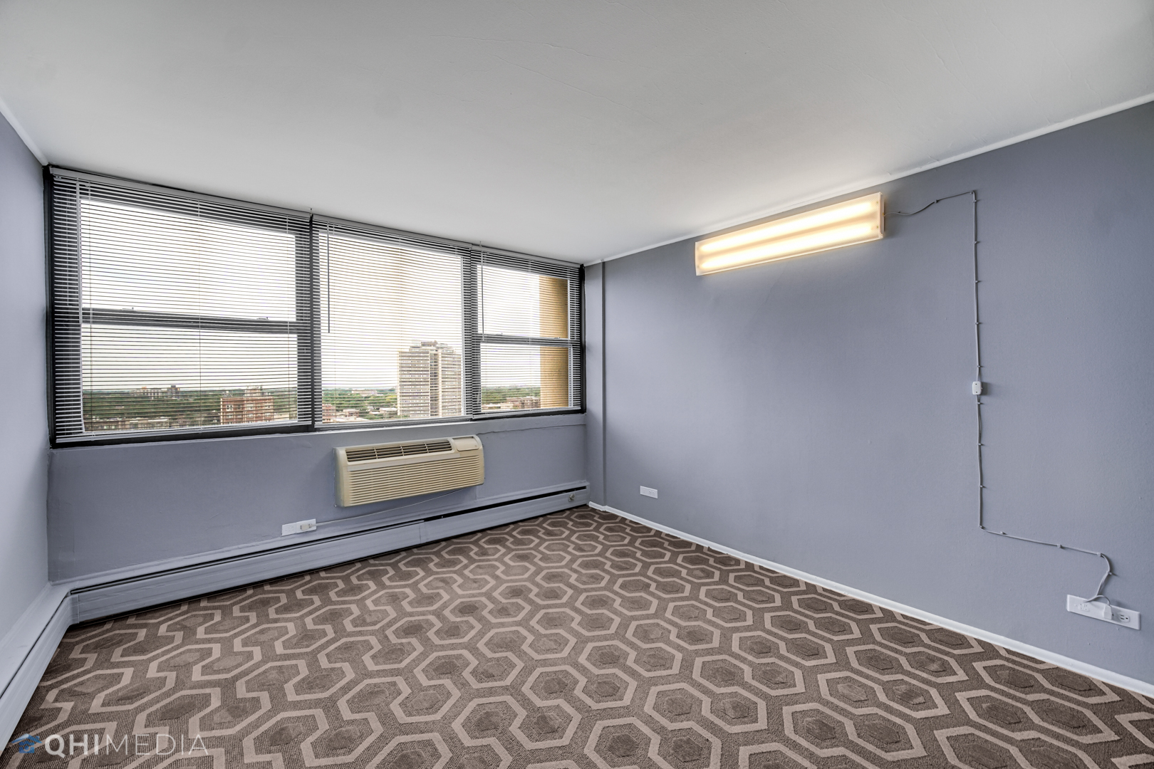 5740 North Sheridan Road, Unit 12C Chicago, IL 60660 - Photo 10 of 19 wooden floor in an empty room with a window