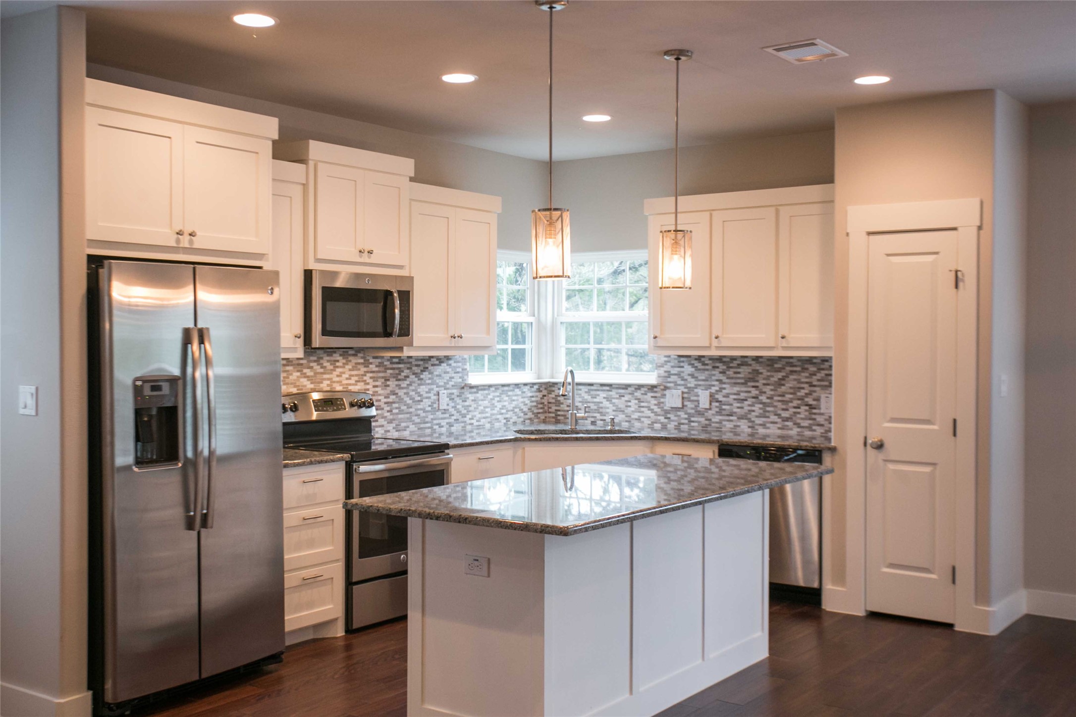 4301 Mansfield Dam Road, Unit 2102 Austin, TX 78734 - Photo 8 of 9 Gleaming granite countertops and stainless steel appliances elevate this bright, well-lit kitchen.
