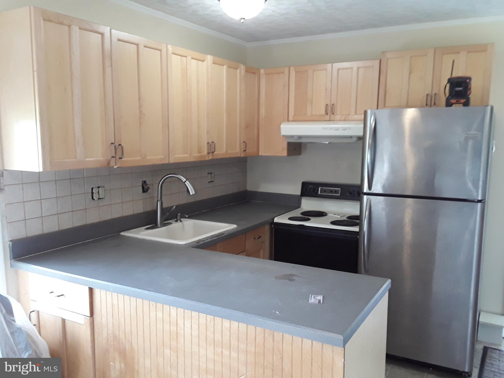 60 Gamewood Road Levittown, PA 19057 - Photo 4 of 10 a kitchen with a refrigerator and a sink
