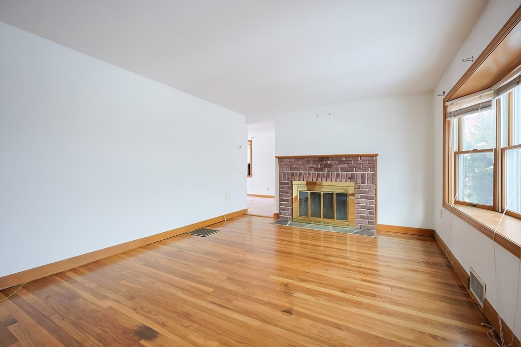17 Kilburn Road Newton, MA 02465 - Photo 8 of 24 wooden floor fireplace and windows in an empty room