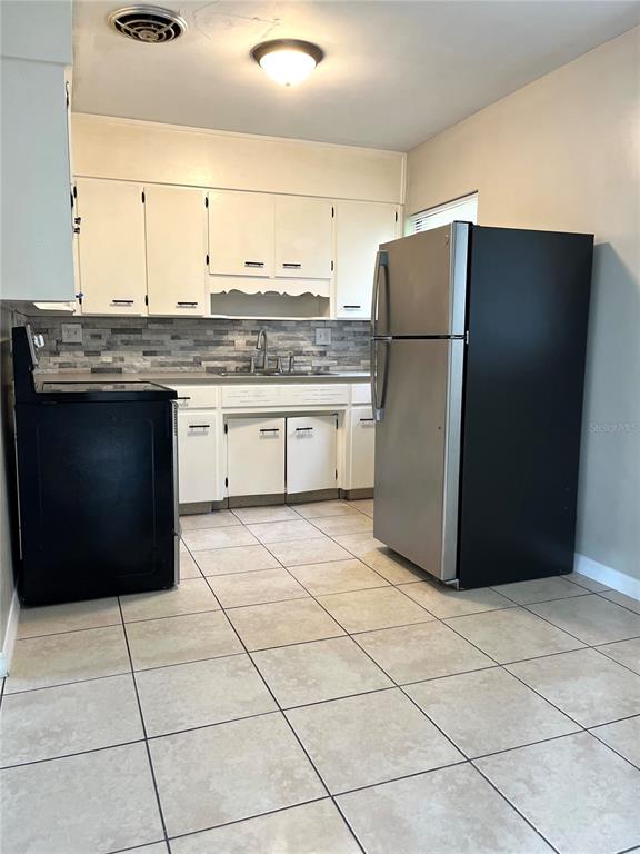 2708 Dixie Road Lakeland, FL 33801 - Photo 5 of 12 a kitchen with stainless steel appliances granite countertop a refrigerator and a sink