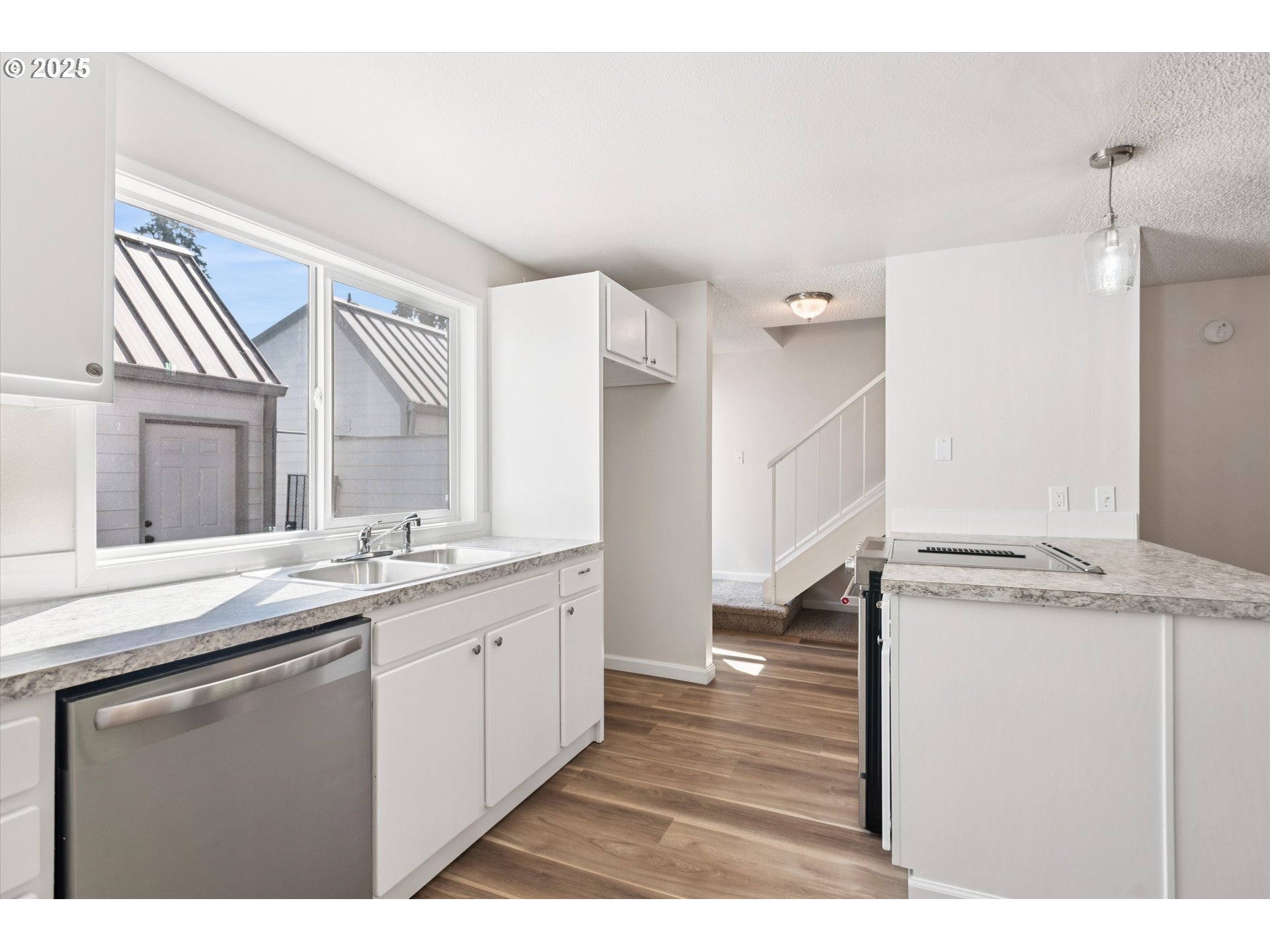 1200 Northeast Territorial Road, Unit 93 Canby, OR 97013 - Photo 15 of 36 a kitchen with a sink cabinets and wooden floor