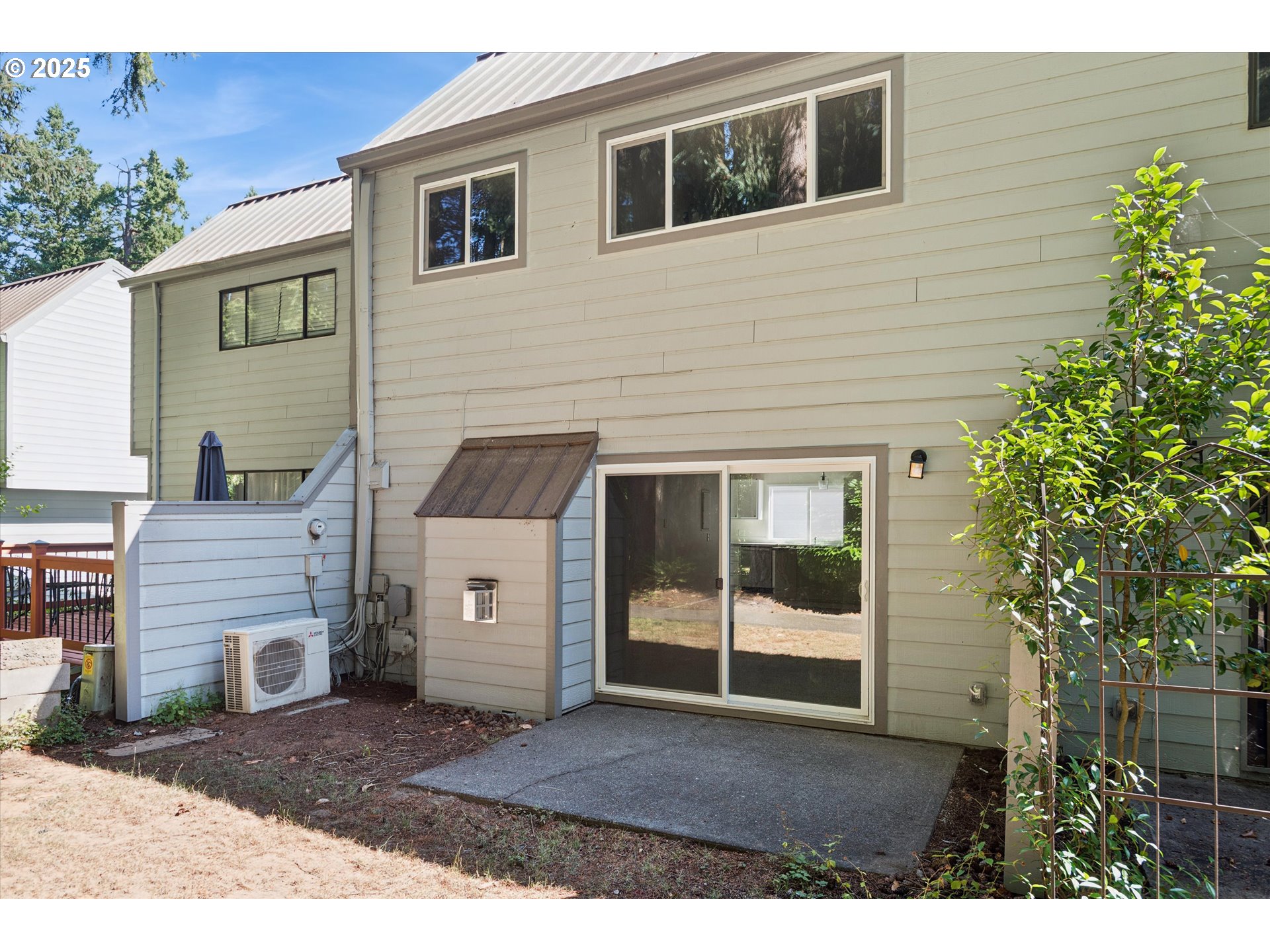 1200 Northeast Territorial Road, Unit 93 Canby, OR 97013 - Photo 31 of 36 a view of a house with a large window and potted plants