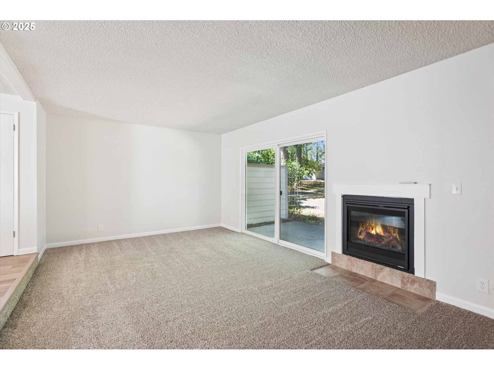1200 Northeast Territorial Road, Unit 93 Canby, OR 97013 - Photo 8 of 36 a view of an empty room with a fireplace and a window
