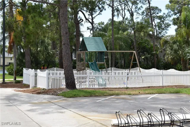 a wooden fence with trees in the background