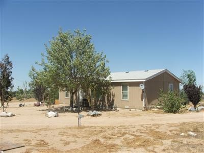 6887 Nielson Road Phelan, CA 92371 - Photo 1 of 1 a view of a house with snow on the road
