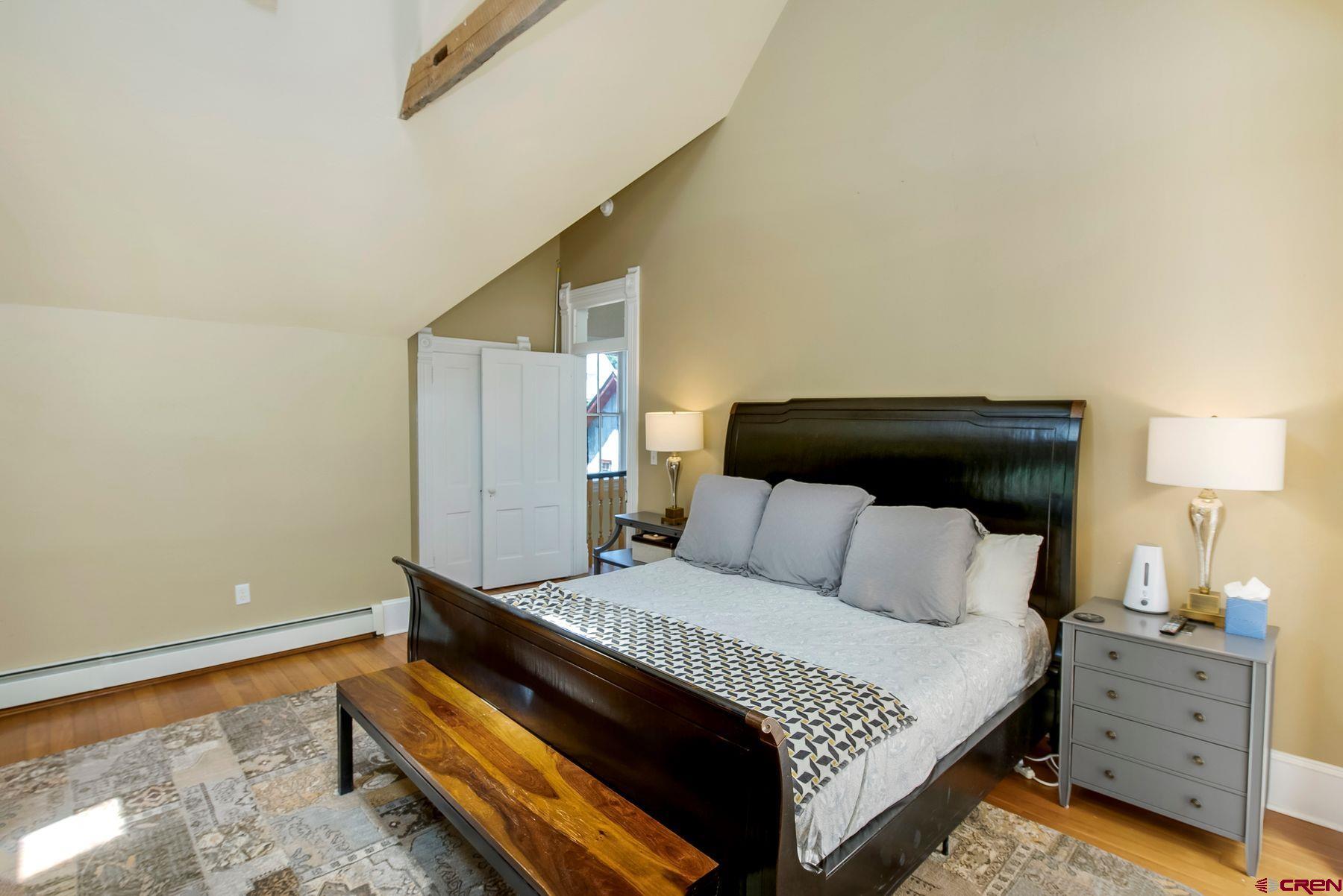 721 Maroon Avenue Crested Butte, CO 81224 - Photo 12 of 31 a bedroom with a bed and a lamp on the dresser