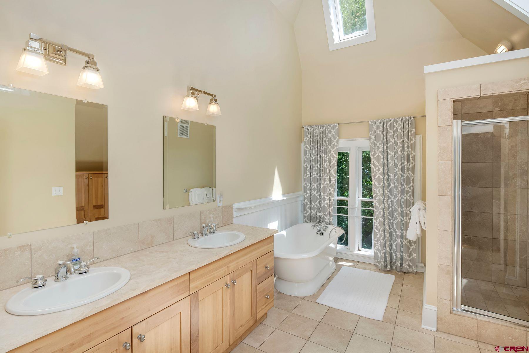 721 Maroon Avenue Crested Butte, CO 81224 - Photo 13 of 31 a spacious bathroom with a double vanity sink toilet mirror and shower