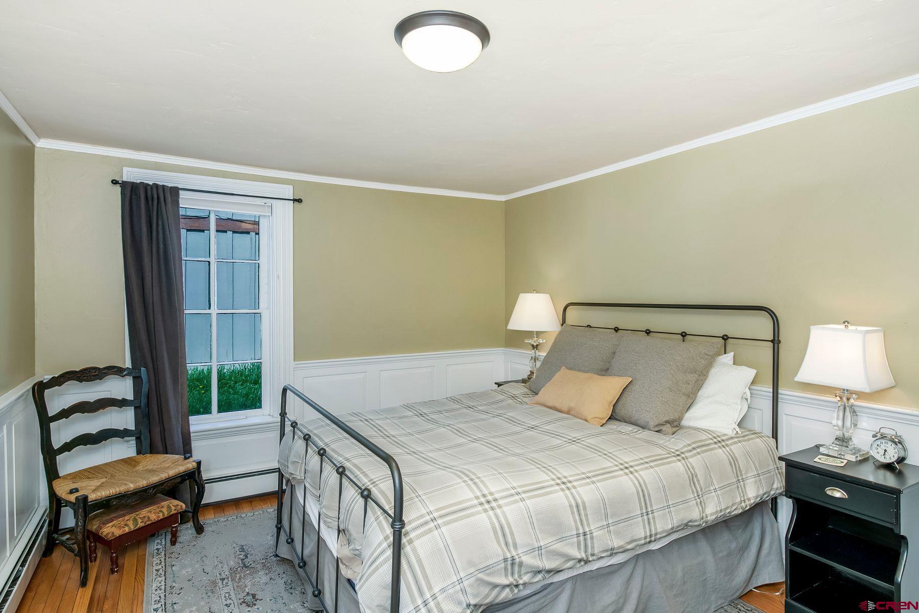 721 Maroon Avenue Crested Butte, CO 81224 - Photo 20 of 31 a bedroom with a bed and a chair