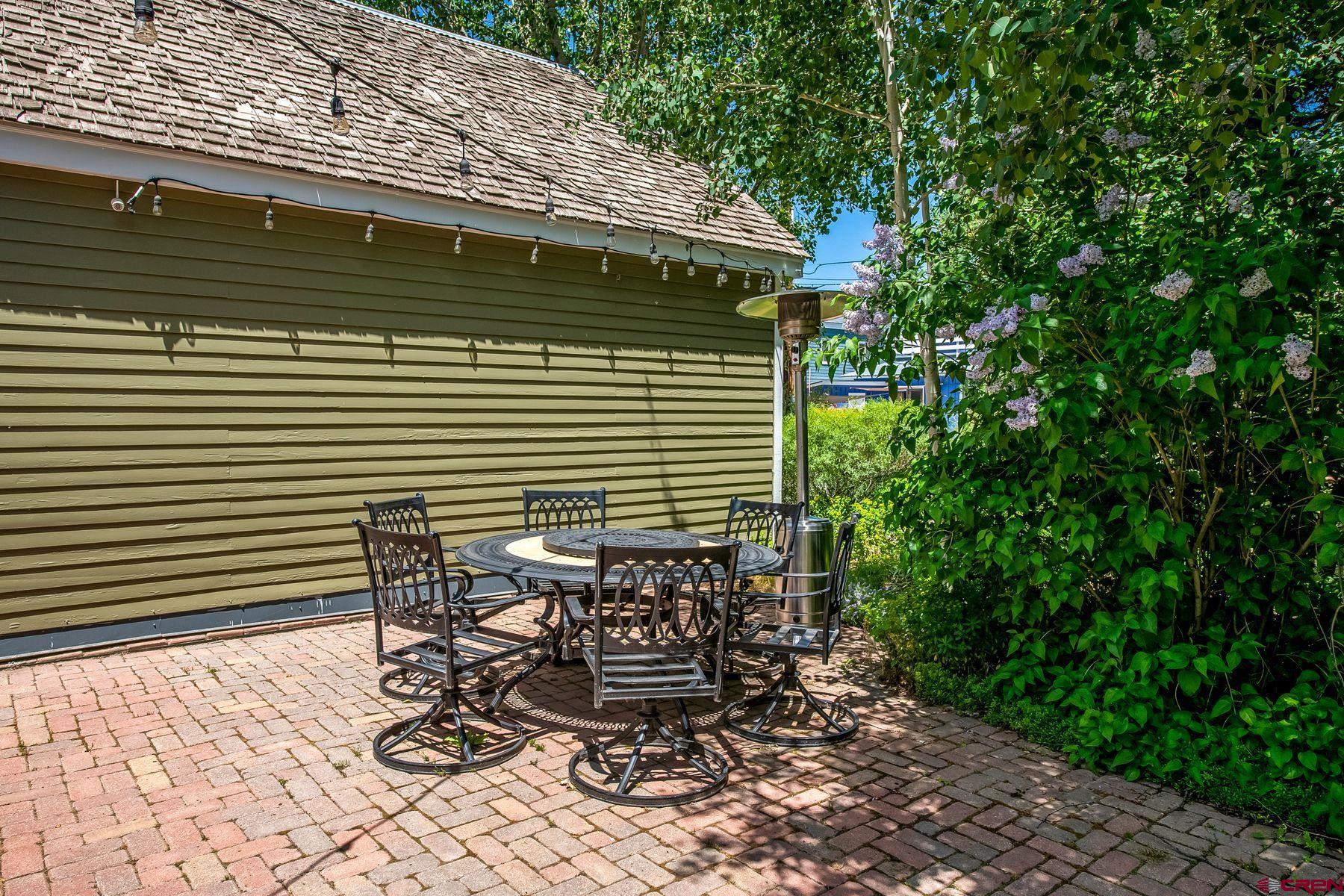 721 Maroon Avenue Crested Butte, CO 81224 - Photo 25 of 31 a view of a chairs and table in backyard