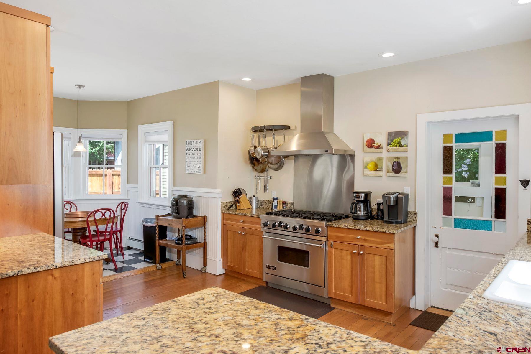 721 Maroon Avenue Crested Butte, CO 81224 - Photo 6 of 31 a kitchen with stainless steel appliances a stove a sink cabinets and a dining table