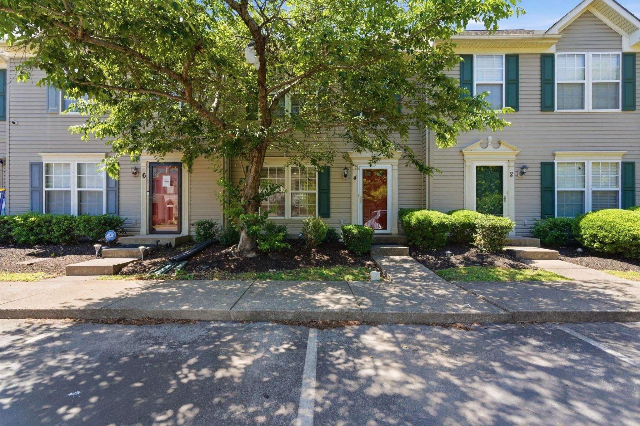 a front view of house with yard and trees around