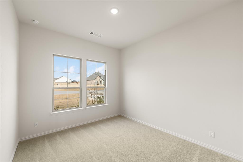 125 Snowy Owl Trail Rhome, TX 76078 - Photo 6 of 28 Empty room featuring light carpet and baseboards