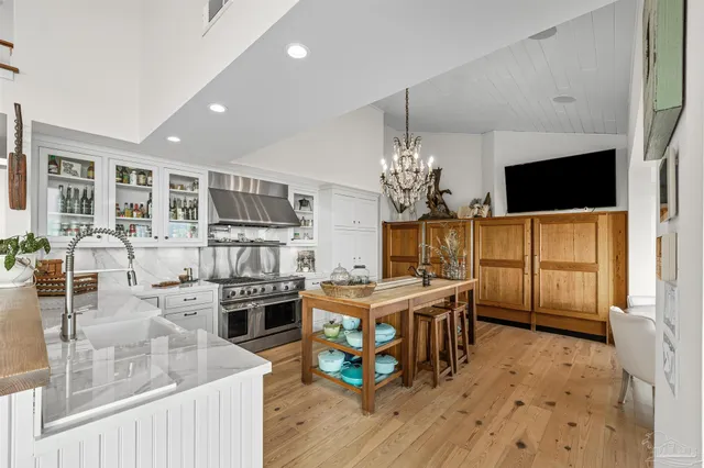 a kitchen with stainless steel appliances granite countertop a stove and cabinets